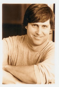 Close up Photo of Jonathan Phillips smiling in black and white